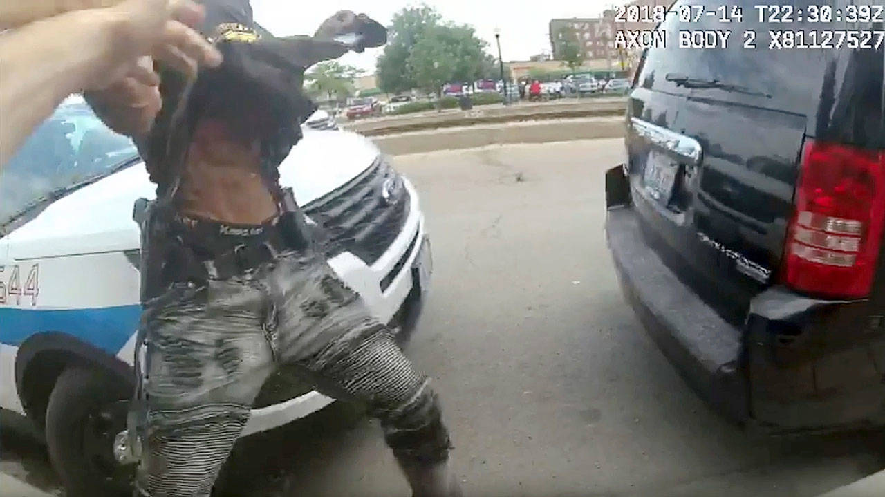 This frame grab from police body cam video provided by the Chicago Police Department shows authorities trying to apprehend a suspect who appeared to be armed, Saturday in Chicago. The suspect was fatally shot by police during the confrontation. (Chicago Police Department via AP)