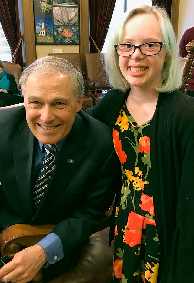 Emma Patterson, 16, poses with Gov. Jay Inslee while she and her mother, Amy Patterson (not pictured), were in Olympia to testify about the Achieving a Better Life Experience legislation. ABLE allows people with disabilities to save money in a tax-exempt account without losing public benefits such as Medicaid. (Courtesy of Amy Patterson)