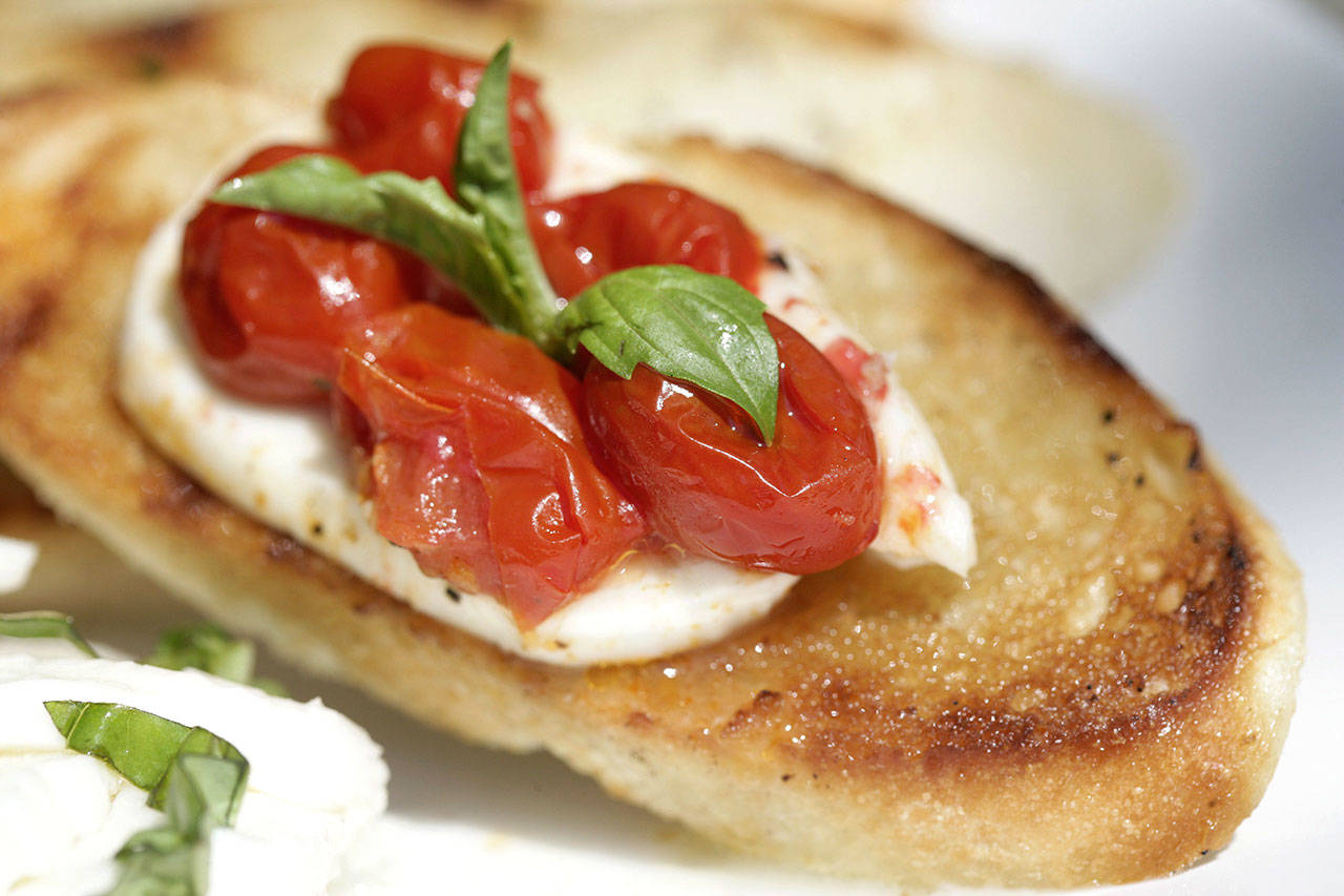 You can drizzle caprese crostini with drizzle olive oil, balsamic glaze and even pesto. (Patricia Beck/Detroit Free Press)