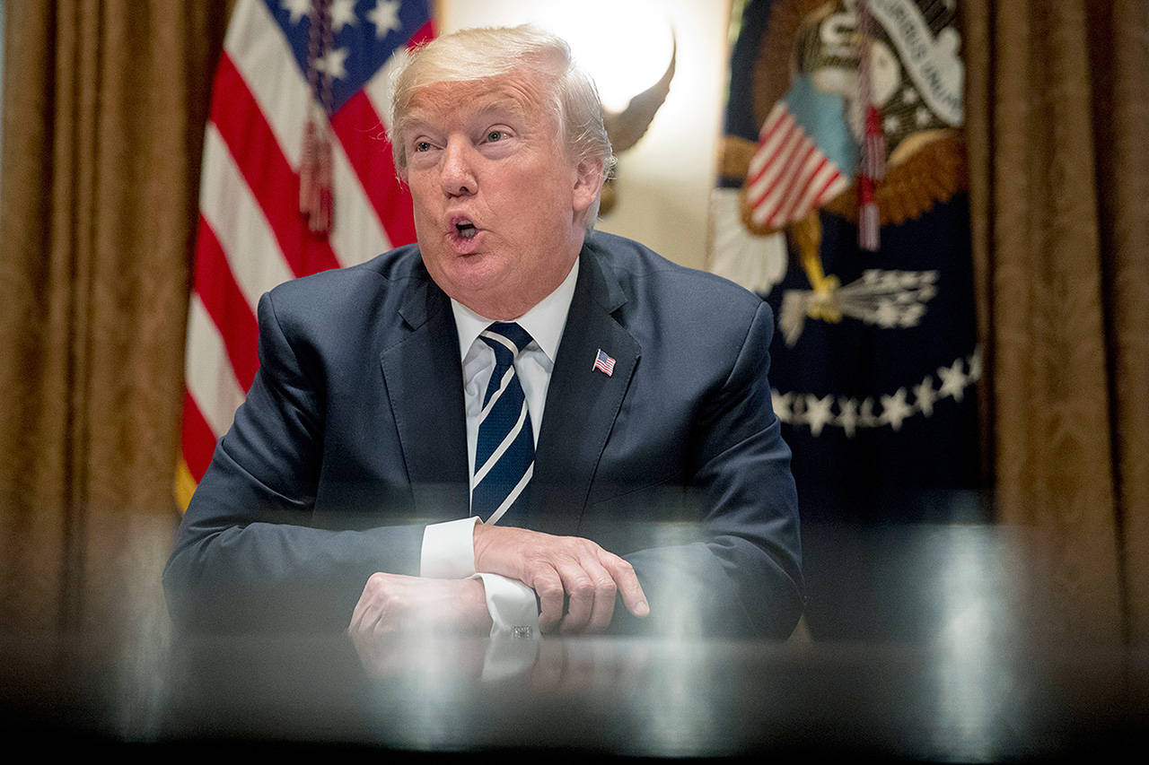 President Donald Trump speaks to reporters as he meets with members of Congress in the Cabinet Room of the White House on Tuesday in Washington. (AP Photo/Andrew Harnik)
