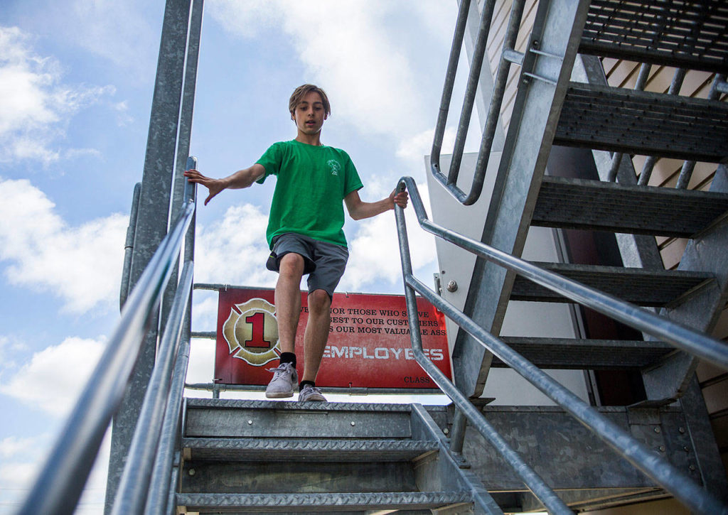 Alex Bonhan, 13, runs down the stairs of a training tower at the obsitcal course station during Kids Fire Camp at South County Fire Administrative Headquarters on Wednesday in Everett. (Olivia Vanni / The Herald)

