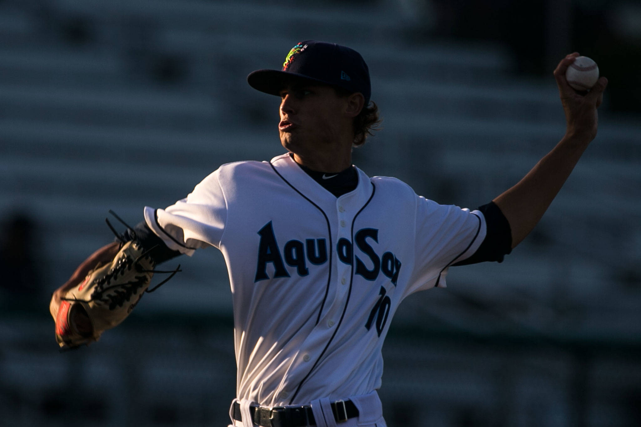 AquaSox pitcher Max Roberts throws a pitch in the setting sun against the Indians on July 17, 2018, at Everett Memorial Stadium. (Kevin Clark / The Herald)