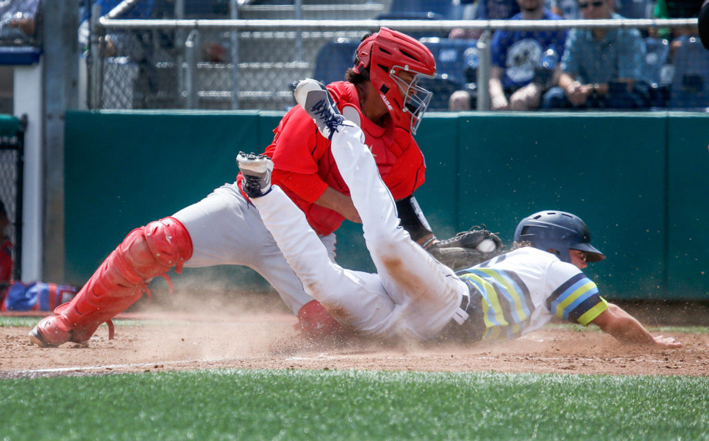 Everett’s Connor Hoover is tagged out at home plate by Spokane’s Francisco Ventura during Wednesday’s game at Everett Memorial Stadium. (Andy Bronson / The Herald)
