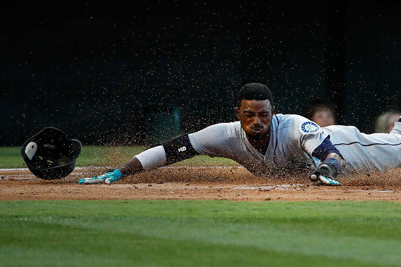 Seattle’s Dee Gordon slides safely into home during the first inning of a July 12 game in Anaheim, Calif. (AP Photo/Jae C. Hong)
