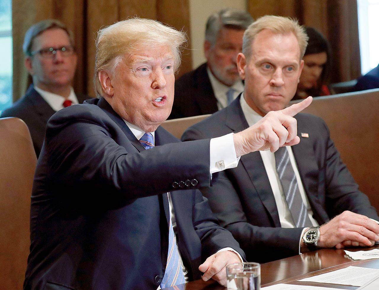 President Donald Trump during his meeting with members of his cabinet in Cabinet Room of the White House in Washington on Wednesday. Looking on is Deputy Secretary of Defense Patrick Shanahan. (AP Photo/Pablo Martinez Monsivais)