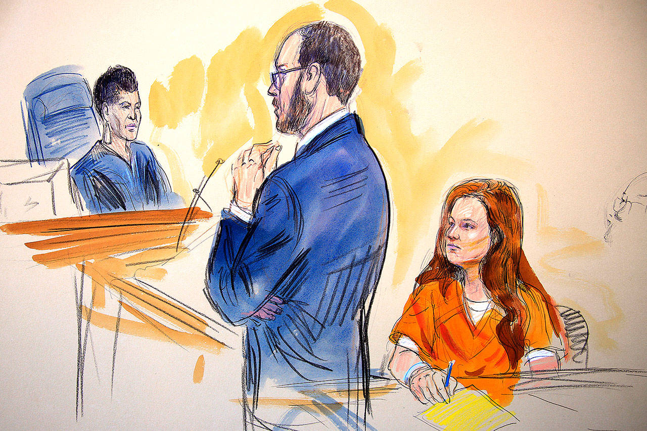 This courtroom sketch depicts Maria Butina, a 29-year-old gun-rights activist suspected of being a covert Russian agent, listening to Assistant U.S. Attorney Erik Kenerson as he speaks to Judge Deborah Robinson (left) during a hearing in federal court in Washington on Wednesday. (Dana Verkouteren via AP)