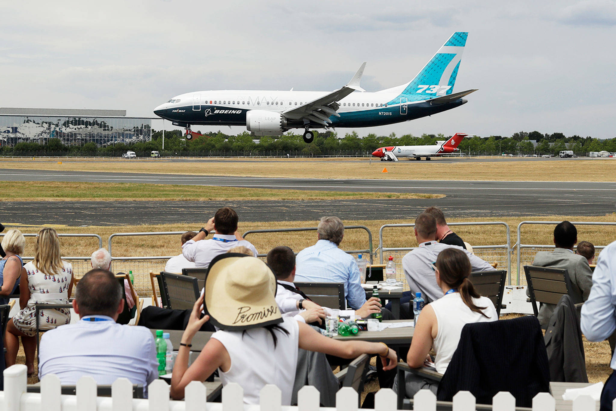 Spectators watch a Boeing 737 land after a flying display at the Farnborough Airshow in Farnborough, England, on Monday. (AP Photo/Matt Dunham)
