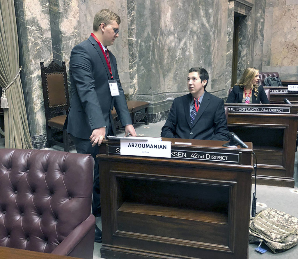 Youth and Government Sens. Jakob Burke and Alexander Arzoumanian discuss an upcoming bill on the Senate Floor in during the annual conference in May. (Courtesy of Nolan Martin)
