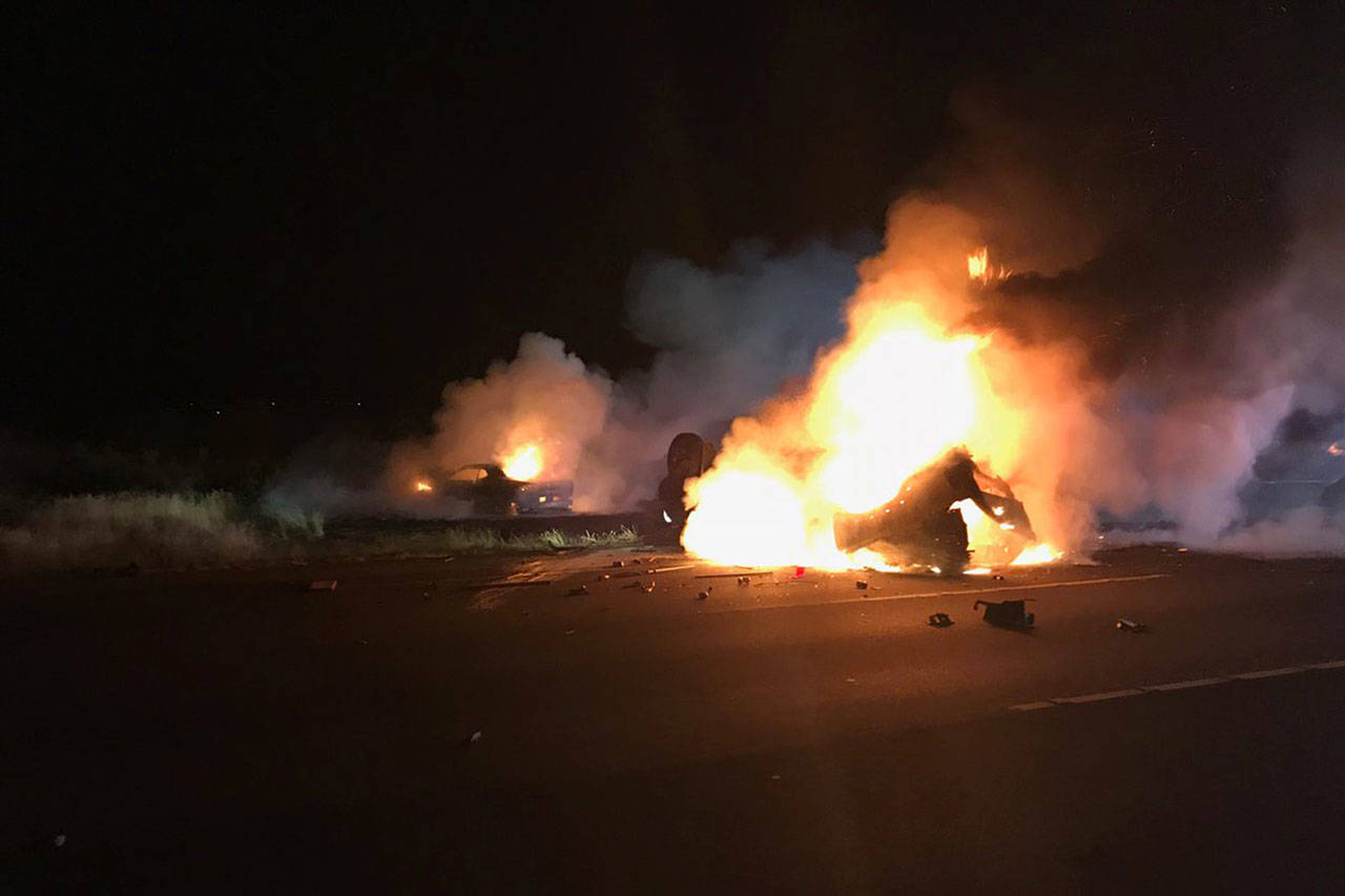 A rear-end crash caused a car to rollover and both to catch fire Wednesday evening on northbound I-5 in Marysville. Both drivers escaped with minor injuries. (Marysville Fire Department)
