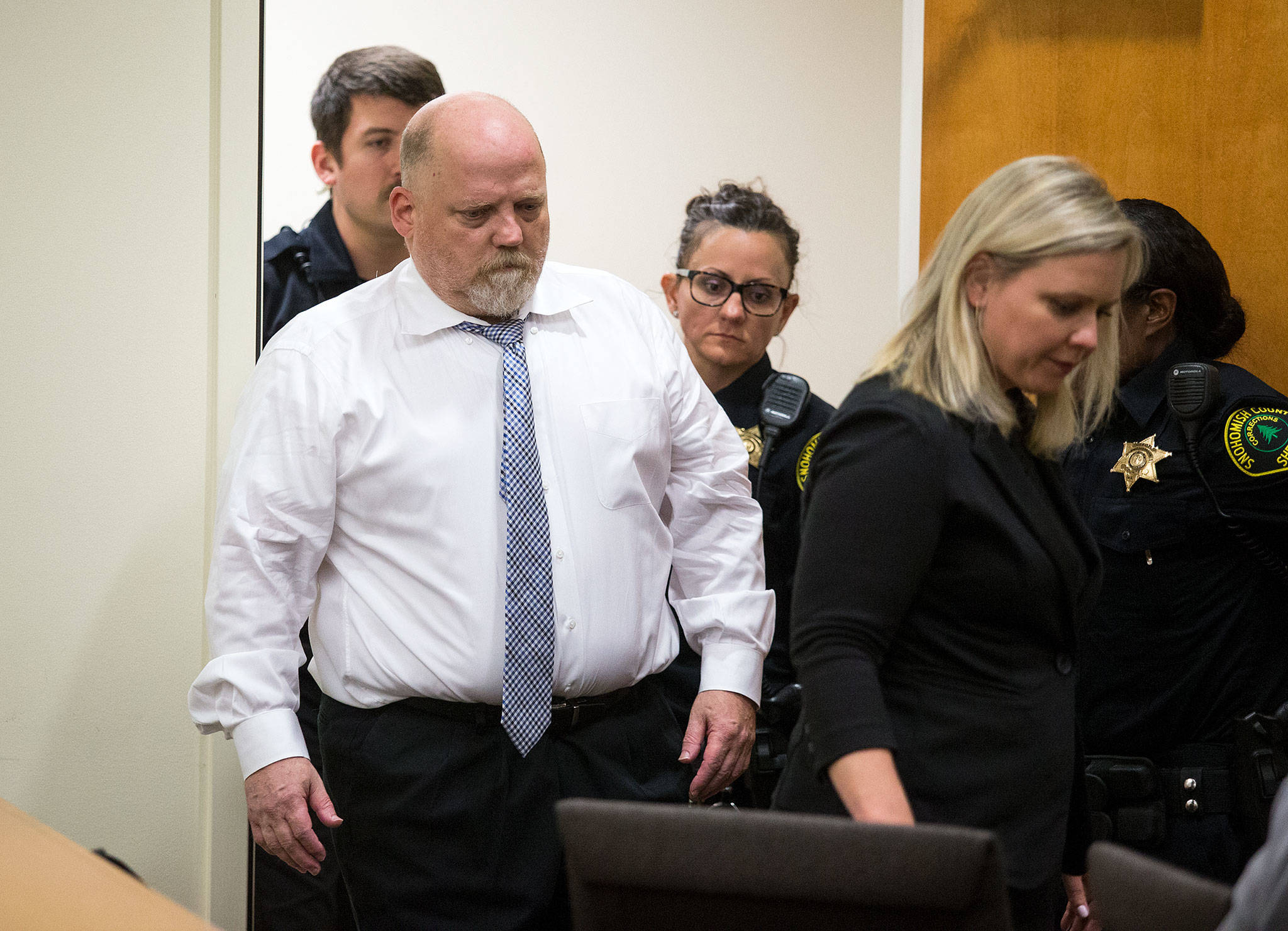 William Earl Talbott II (left), with defense attorney Rachel Forde (right), enters a courtroom for his arraignment June 19 in Everett. (Andy Bronson / The Herald)