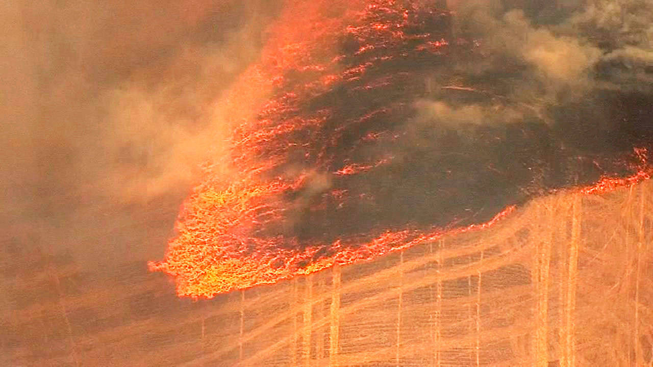 A grassland fire burns Wednesday near The Dalles, Oregon. The deadly, fast-moving fire is being fueled by gusting winds, forced dozens of households to evacuate and is threatening to impact what is expected to be a big harvest of wheat. (FOX-12 News via AP)