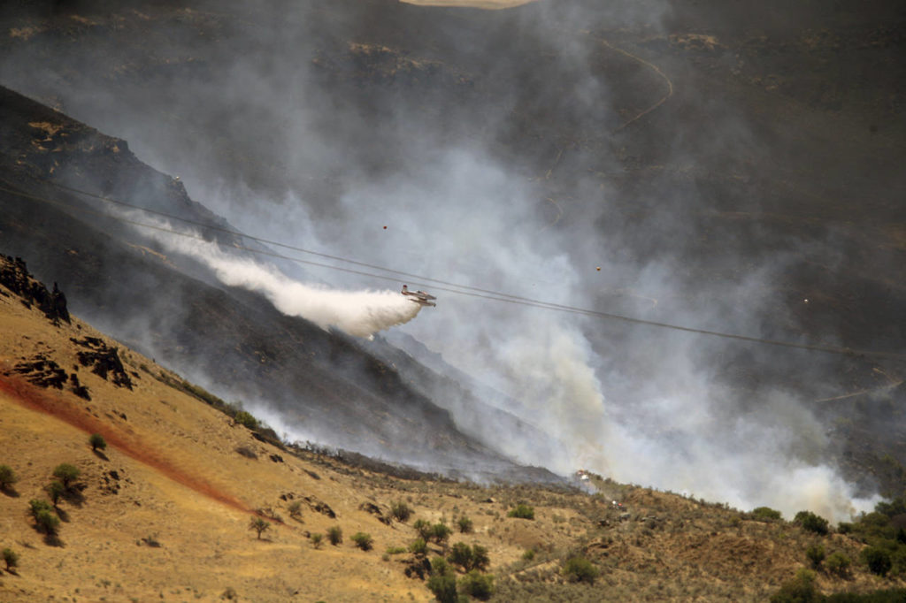 The Substation fire near where the Deschutes and Columbia Rivers meet along I-84 and SR 15 east of Portland, Oregon, burns Thursday. (Mark Graves/The Oregonian via AP)
