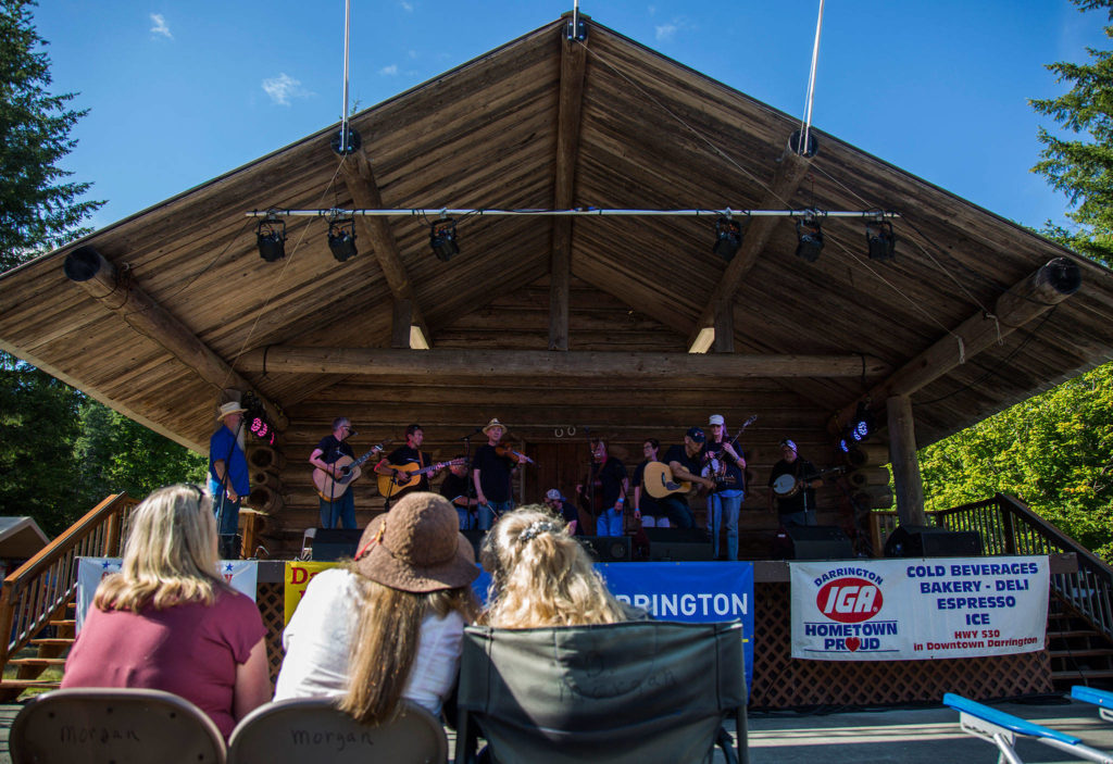People watch as the “Where’s Norm?” group comes on stage for open mic during the Darrington Bluegrass Festival on Saturday, July 21, 2018 in Darrington, Wa. (Olivia Vanni / The Herald)
