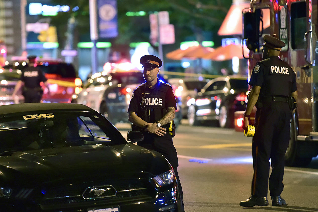 Police work the scene of a shooting in Toronto on Sunday. (Frank Gunn/The Canadian Press via AP)