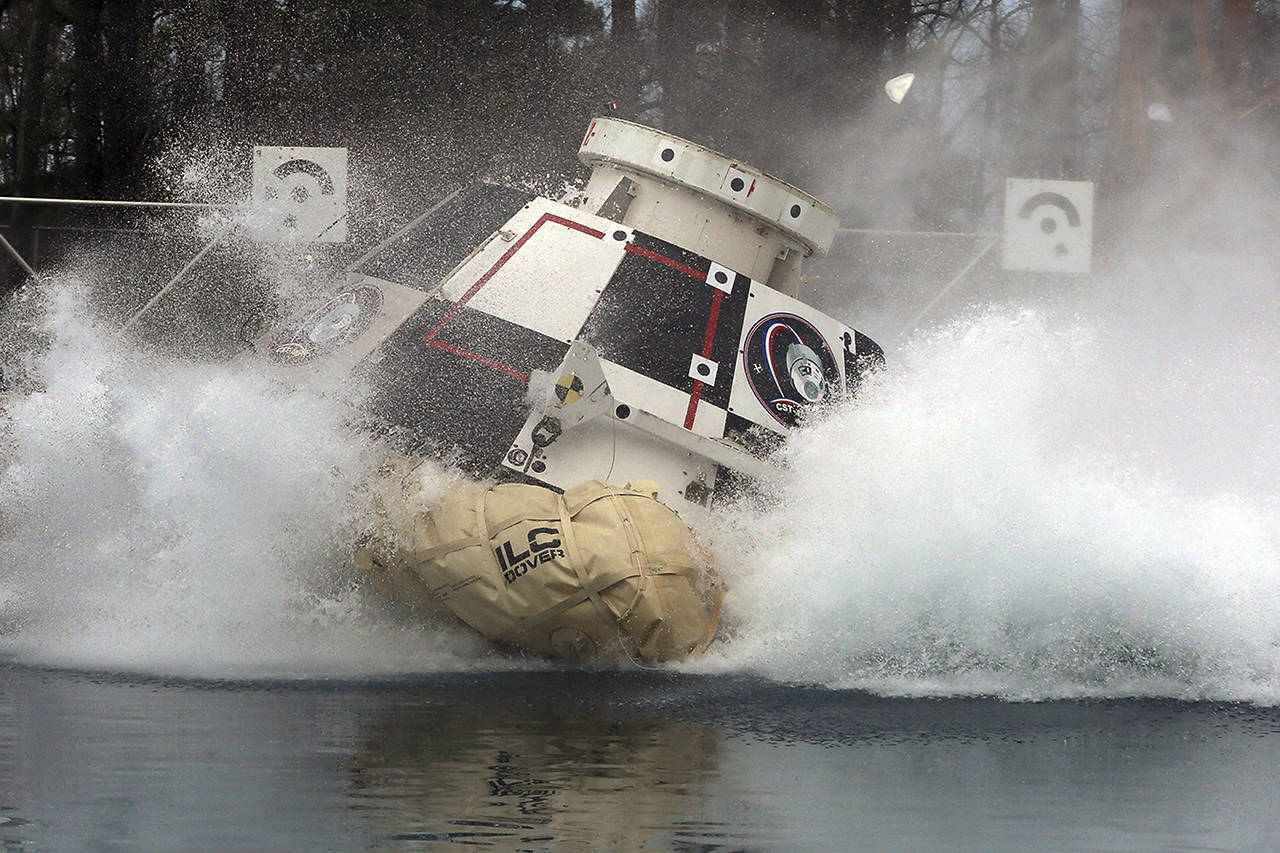In this 2016 photo, a mockup of Boeing’s CST-100 Starliner spacecraft, in development in partnership with NASA’s Commercial Crew Program, splashes into a 20-foot-deep basin at NASA’s Langley Research Center in Hampton, Virginia, during testing of the spacecraft’s landing systems design. (David C. Bowman/NASA via AP)