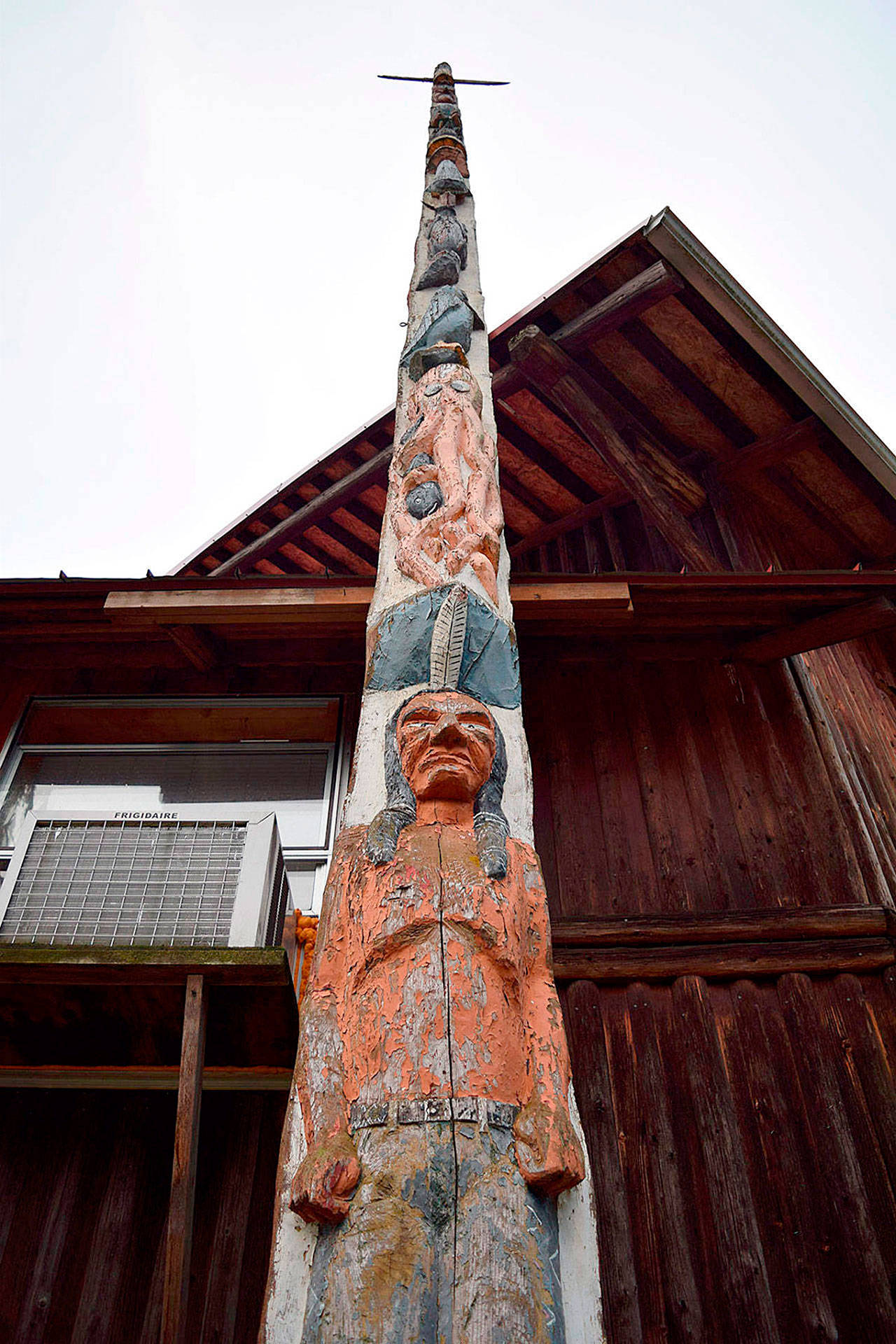 The story pole at Island County Fairgrounds has greeted thousands of visitors for more than 70 years. But who carved it and how and when it ended up at the fair is a mystery that the South Whidbey Historical Society is trying to solve. (Record file photo)