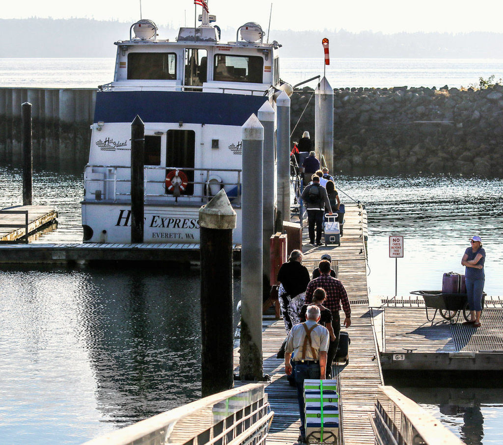 Just a half-hour after arriving from Everett and unloading early Thursday, the Hat Express begins loading passengers and their carry-ons for the trip back to Everett.(Dan Bates / The Herald)
