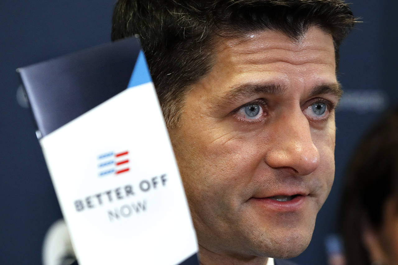 House Speaker Paul Ryan holds up a pamphlet that says “Better Off Now” while speaking during a news conference following a GOP caucus meeting Tuesday on Capitol Hill in Washington. (AP Photo/Jacquelyn Martin)