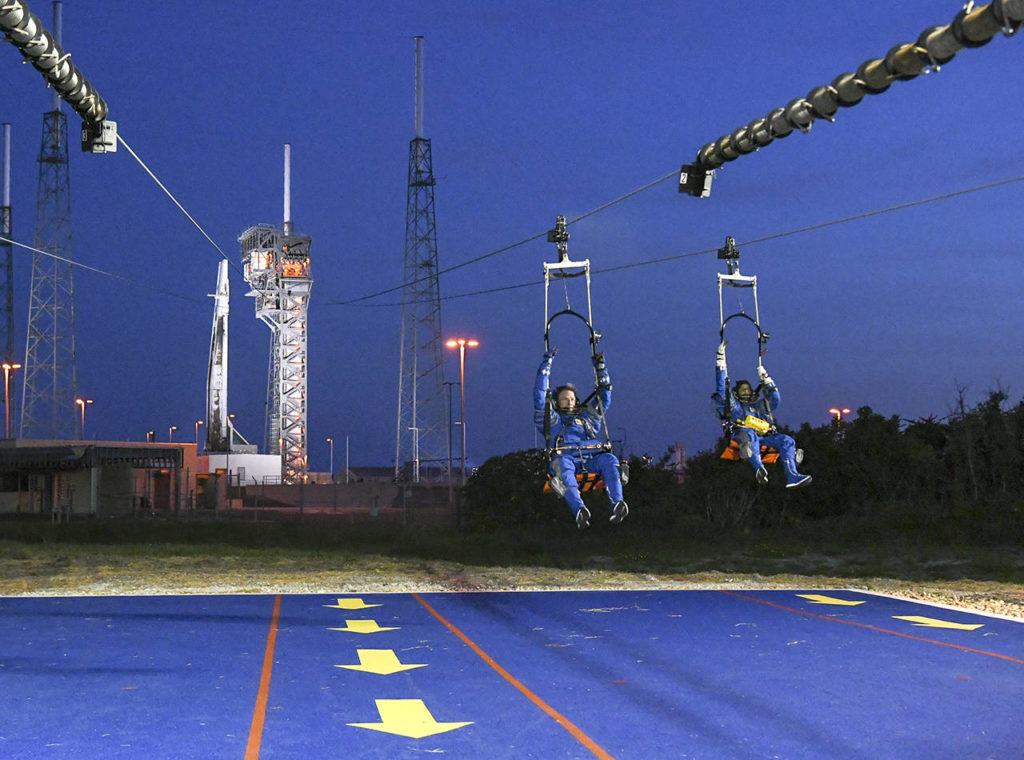 Chris Ferguson and Suni Williams practice an emergency escape from the crew access tower at Launch Complex 41 at the Kennedy Space Center in Florida. (Jonathan Newton/Washington Post)
