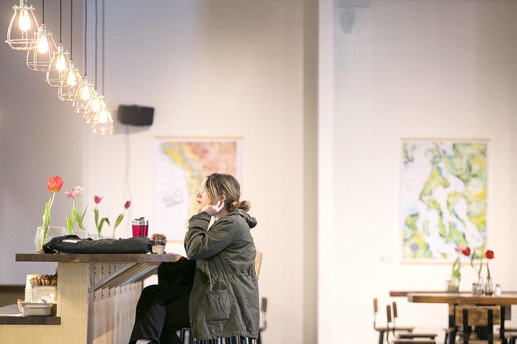 Natanya Bruzzesse-Colley sits at the counter on a recent afternoon at Farms & Market in Everett. (Kevin Clark / The Herald)
