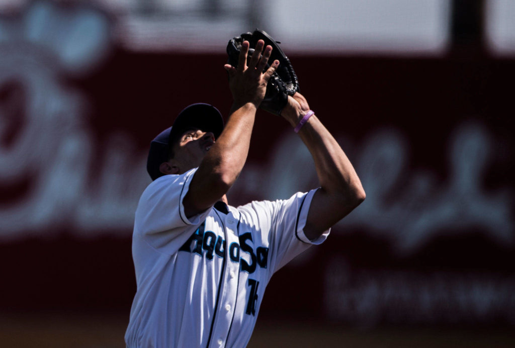 Aquasox’s Ryne Ogren looks into the sun while trying to catch a ball during the game against Vancouver at Everett Memorial Stadium on Thursday, July 26, 2018 in Everett, Wa. (Olivia Vanni / The Herald)
