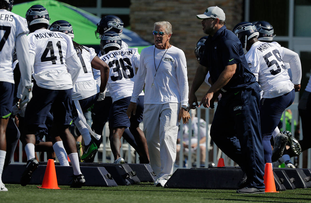 Seattle coach Pete Carroll, watches players during Thursday’s training camp session in Renton. (AP Photo/Ted S. Warren)