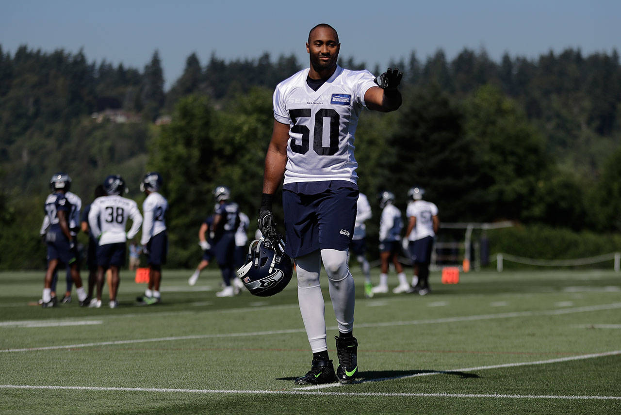 Seattle’s K.J. Wright walks on the field during a training camp session Thursday in Renton. (AP Photo/Ted S. Warren)
