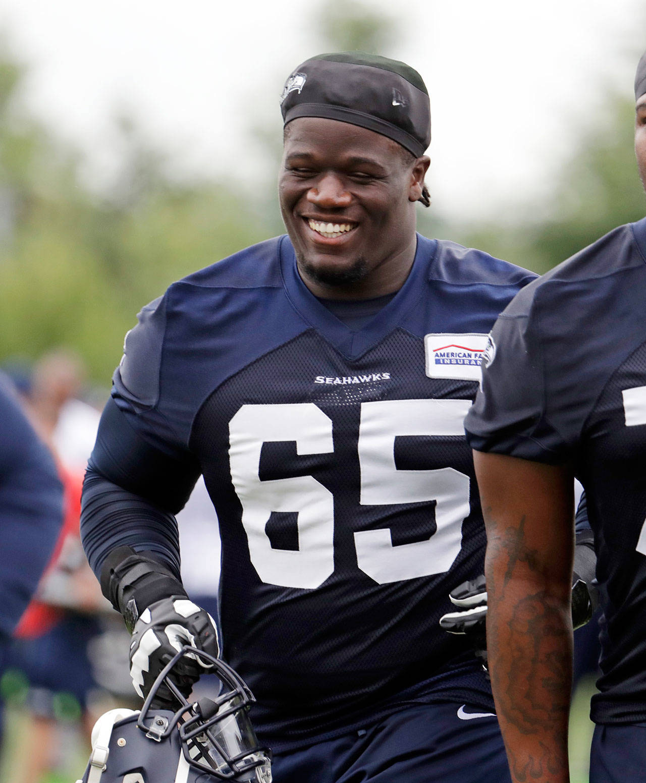 Seattle’s Germain Ifedi runs off the field after a June 12 practice session in Renton. (AP Photo/Elaine Thompson)