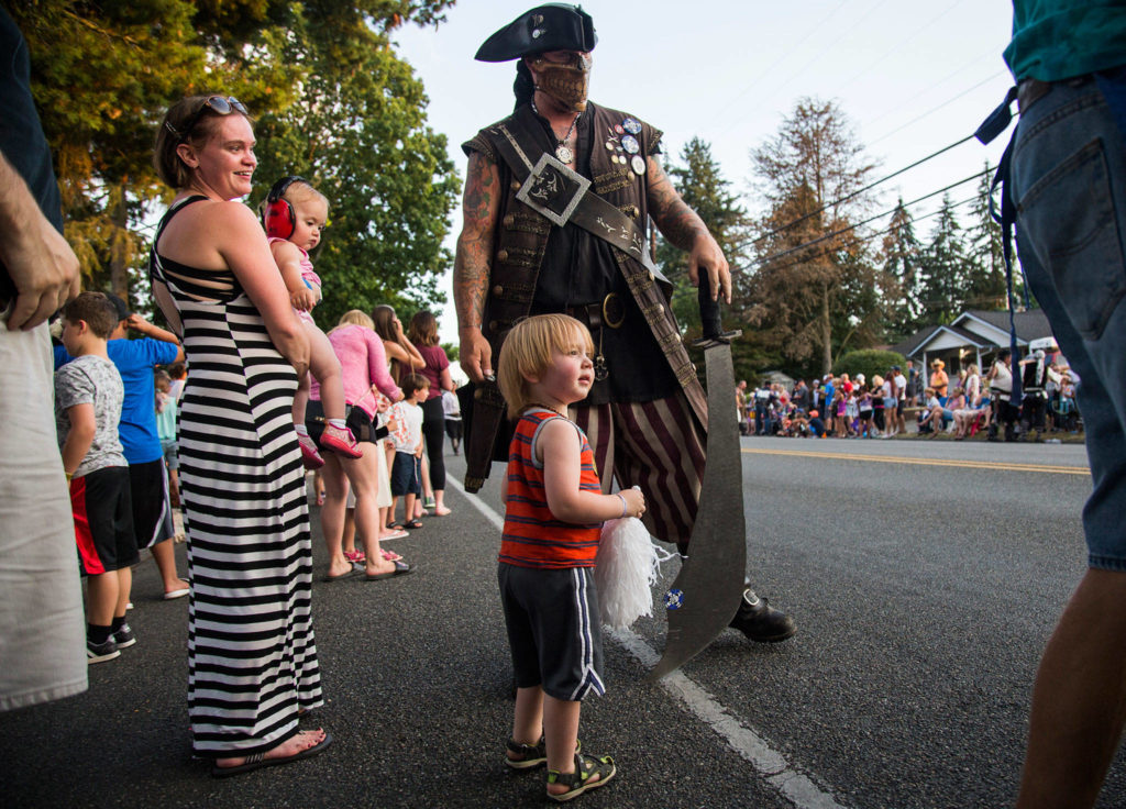 Simon Jones, 3, looks up as the Safari Pirates walk past during the Tour de Terrace parade on Friday, July 27, 2018 in Mountlake Terrace, Wa. (Olivia Vanni / The Herald)
