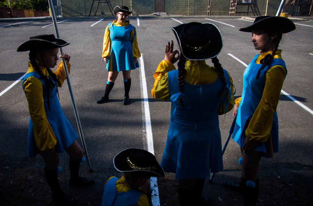 Hailey Whitish talks to other members of the Ballard Eagle Drill Team before the start of the Tour de Terrace parade on Friday, July 27, 2018 in Mountlake Terrace, Wa. (Olivia Vanni / The Herald)
