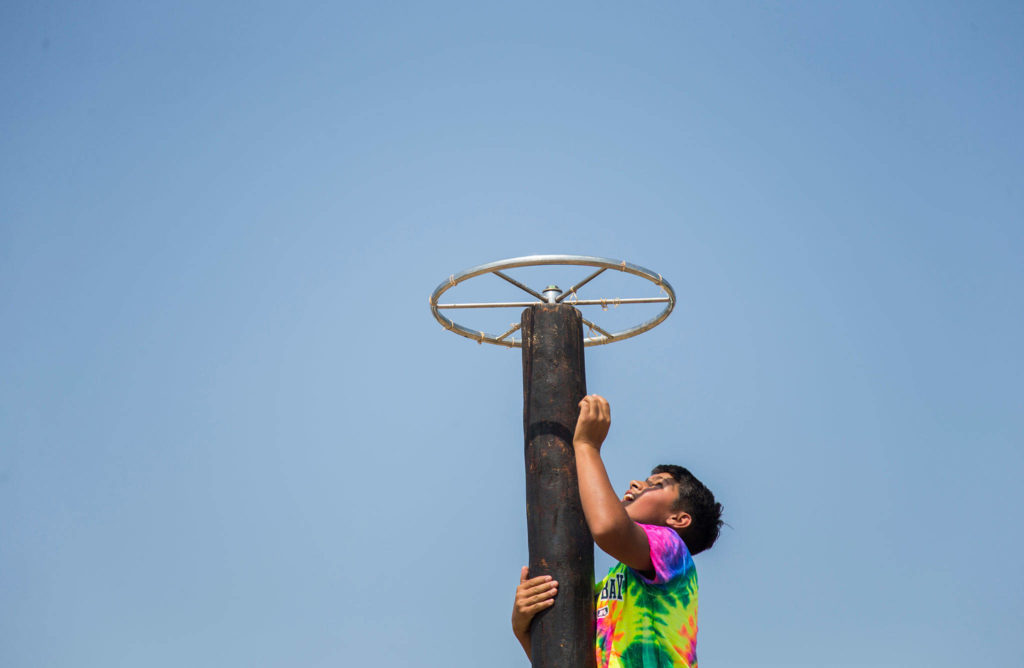 A young boy climbs to the top of a boy obstacle during the Silvana Fair off of Pioneer Highway on Saturday, July 28, 2018 in Silvana, Wa. (Olivia Vanni / The Herald)
