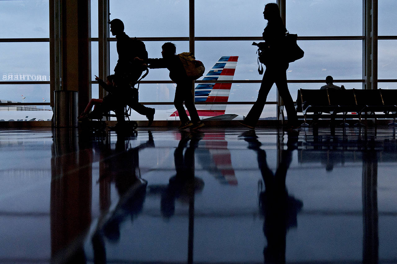Travelers walk through Ronald Reagan National Airport (DCA) in Washington, D.C. (Andrew Harrer/Bloomberg)