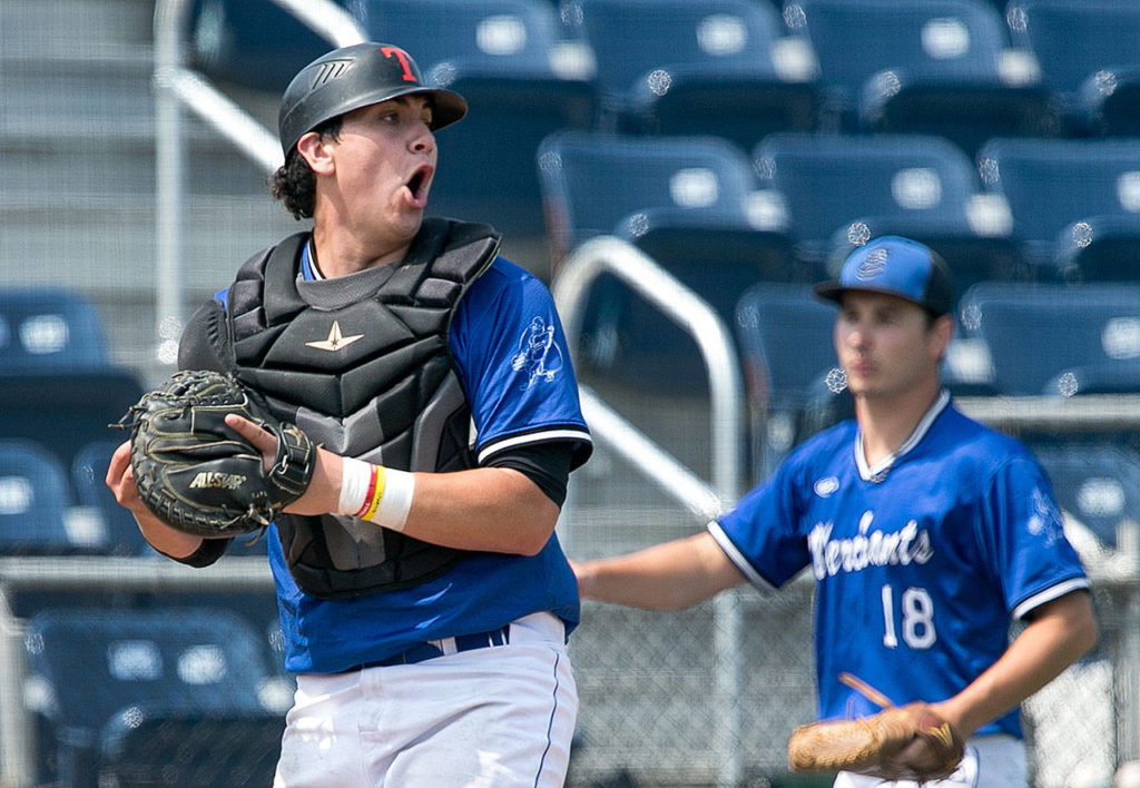 Everett’s Marcus McCannel reacts after making a tag at home plate during the Merchants’ July 28 game against the Seattle Cheney Studs at Everett Memorial Stadium. (Kevin Clark / The Herald)
