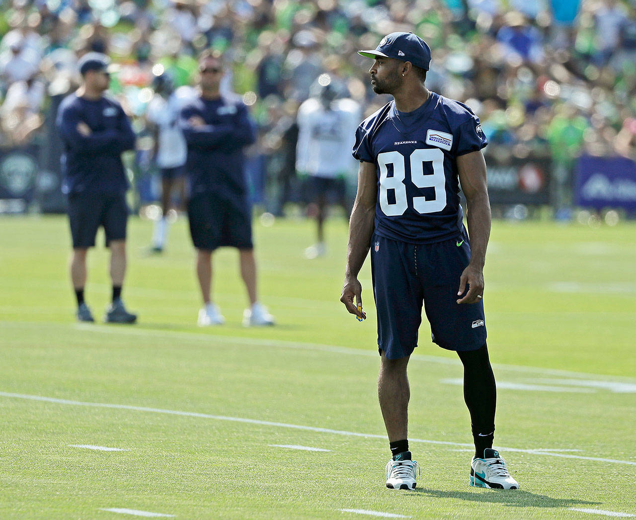 Seattle’s Doug Baldwin stands on the field during Seahawks training camp Sunday in Renton. Baldwin, who has missed three straight days of practice with a knee issue, will be shut down for multiple weeks to let the injury heal. (AP Photo/Ted S. Warren)