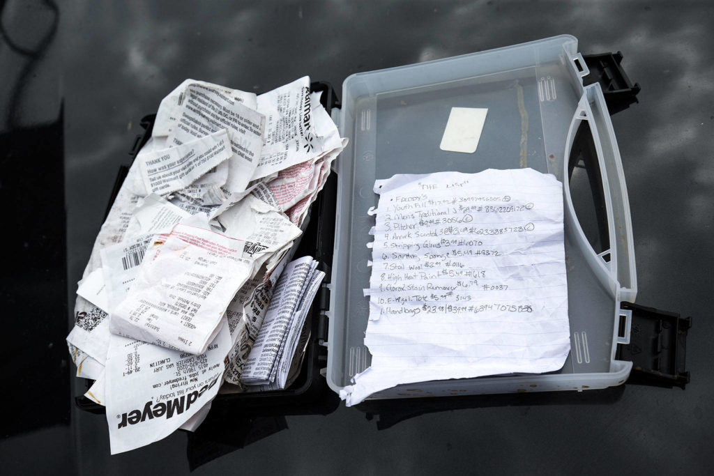 A rip sheet — showing the names of stores, barcode numbers, prices and UPC codes — was found during a search of a vehicle used by shoplifting suspects Thursday, June 14, 2018, in Monroe. Shoplifters find discarded receipts, then make rip sheets to help them organize their thefts. (Andy Bronson / The Herald)
