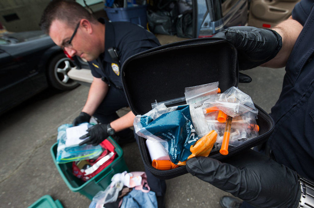 A heroin kit holds a half-full needle and other drug paraphernalia, as Monroe police officers search a car in the department’s impound area on Thursday, June 14, 2018. (Andy Bronson / The Herald)
