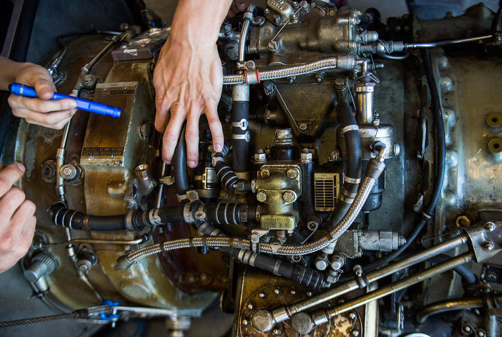 Students inspect a Viper engine during class at Everett Community College’s Aviation Maintenance Technician School on Friday, July 13, 2018 in Everett, Wa. (Olivia Vanni / The Herald)
