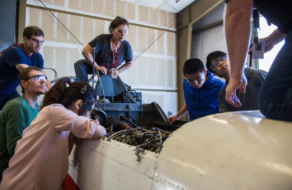 Students listen while teacher Dale Lerback explains what they should be checking before they remove the Viper engine during class at Everett Community College’s Aviation Maintenance Technician School on Friday, July 13, 2018 in Everett, Wa. (Olivia Vanni / The Herald)

