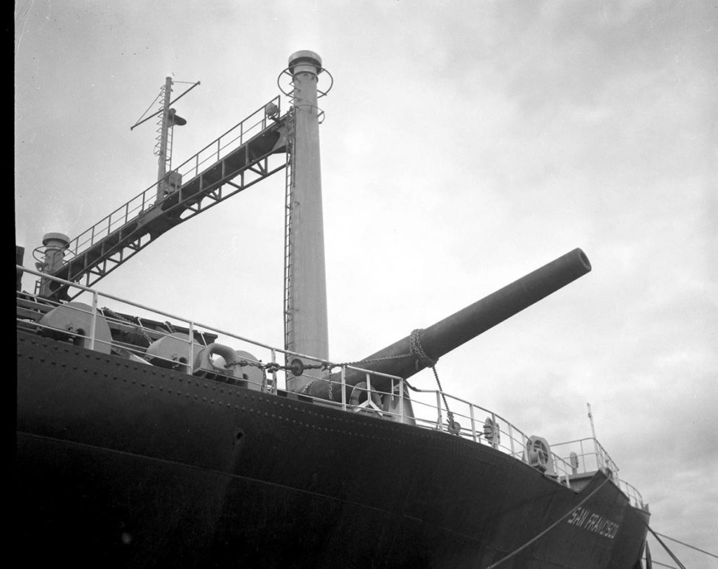 During the passage from the Philippines to Washington, a freak storm at sea caused the cargo ship San Francisco to roll 40 degrees. One of the gun barrels broke loose, flew across the deck and wound up dangling over the side of the ship. It arrived safely in Bremerton in June 1968. (Washington State Parks Collection)
