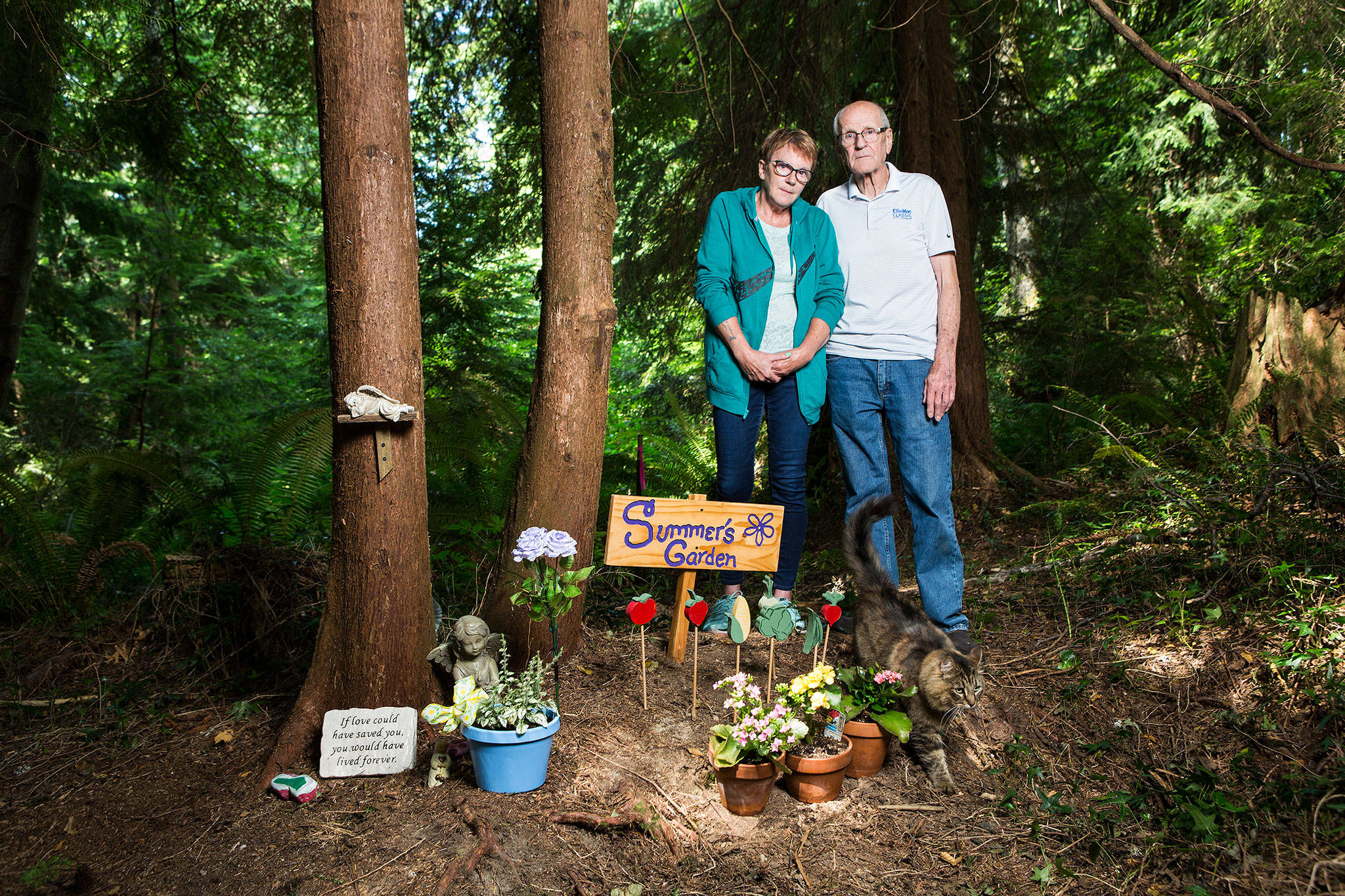 Grandmother, Liz Stevenson and great-grandfather, Al Crippen, at the garden memorial spot where Summer Rae Dolman hung herself in April. Summer Rae’s cat Twix is visible. After Summer’s death, Stevenson found a folded note in Summer’s dresser that she believes had at some point been slipped into the teen’s locker. Cruel messages are scribbled on it. Among them: “You, jump off the school roof” and “Die you lgbt.” (Andy Bronson / The Herald)