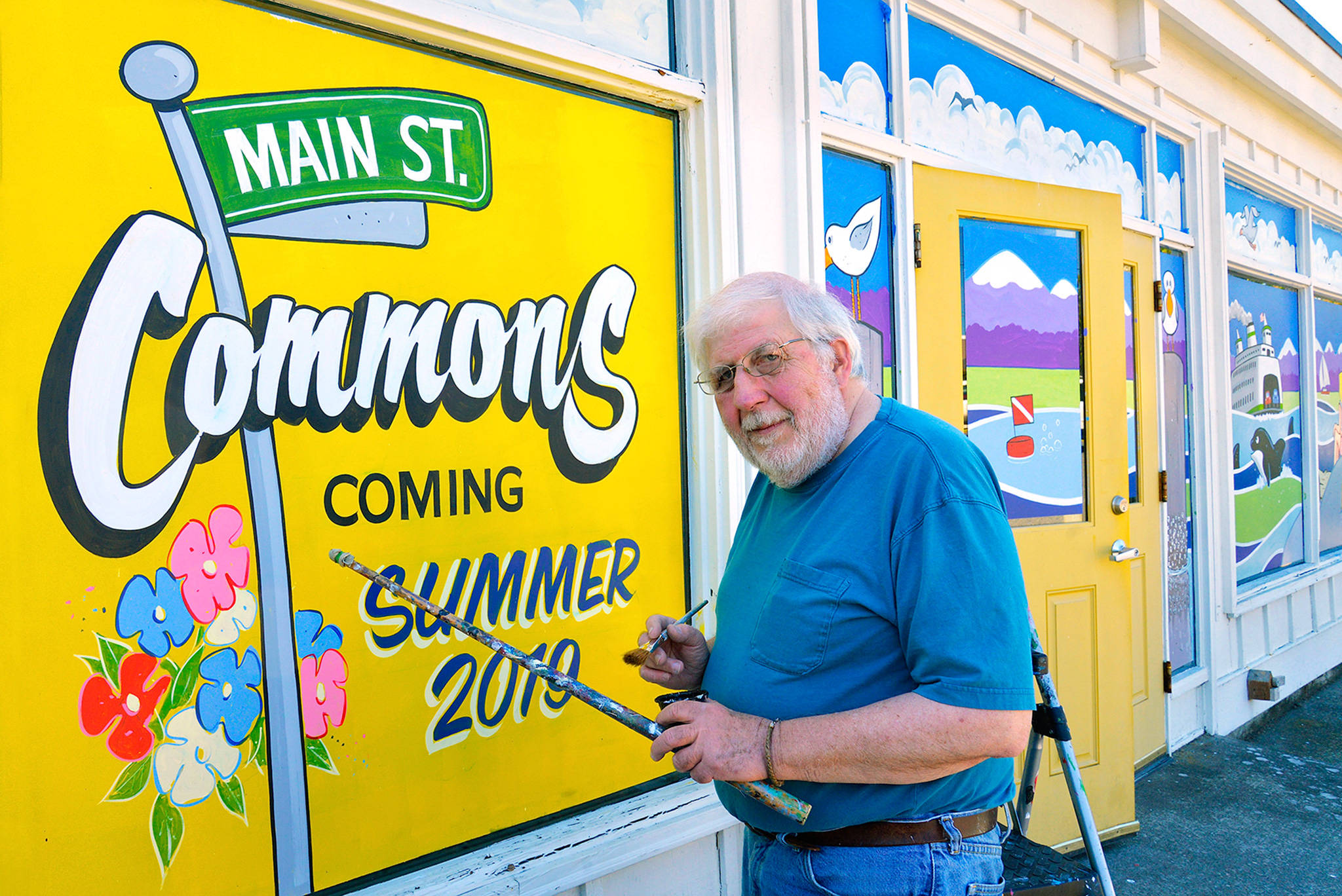 Professional sign painter Mack Benek puts the finishing touches on the windows of an Edmonds building undergoing a transformation. The owner wanted the building to look good while it was empty. Benek, 72, has hand-lettered many signs on windows and businesses in Edmonds and Seattle. (Bob Sears)