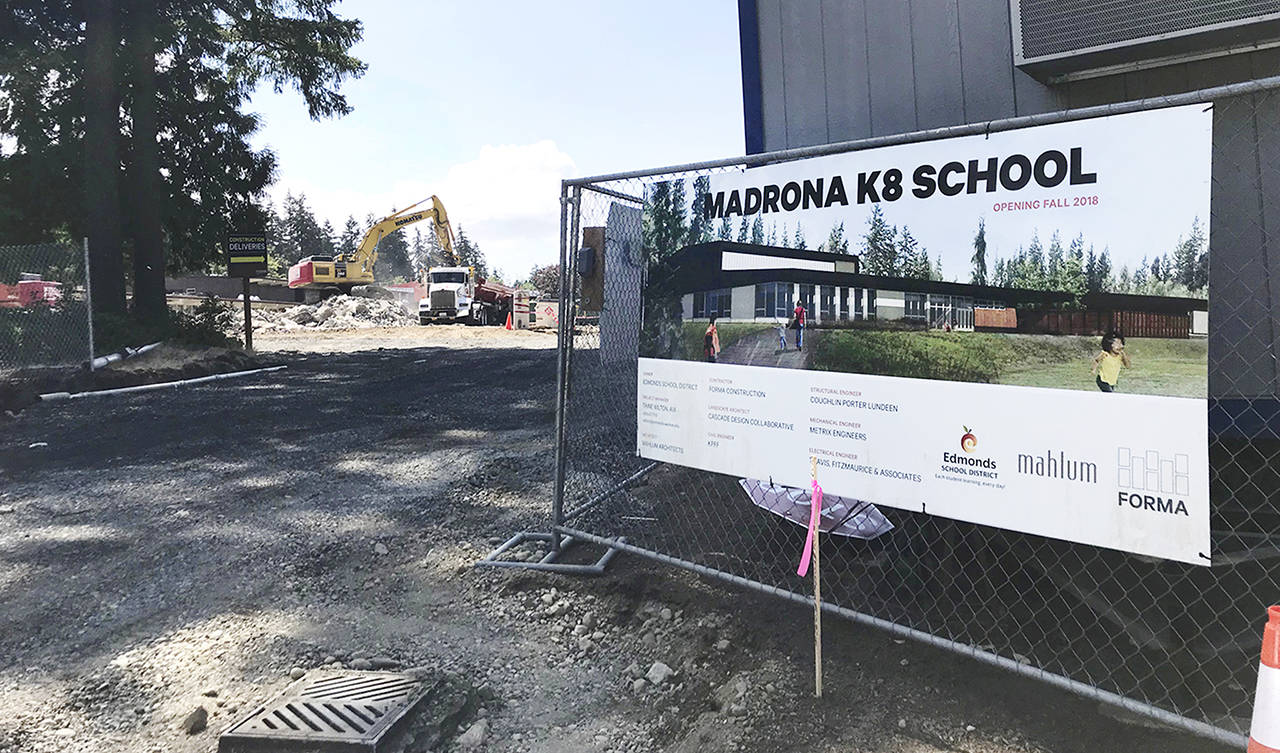 Workers demolish the old building at Madrona K-8 School. Students won’t be starting at the new campus yet. (Stephanie Davey / The Herald)