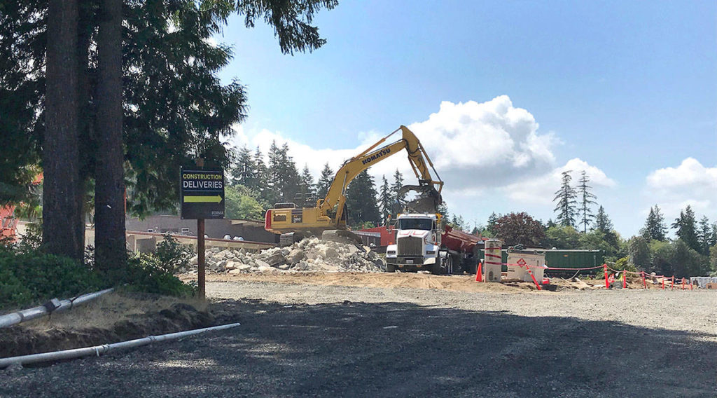 Workers demolish the old building at Madrona K-8 School. Students won’t be starting at the new campus yet. (Stephanie Davey / The Herald)
