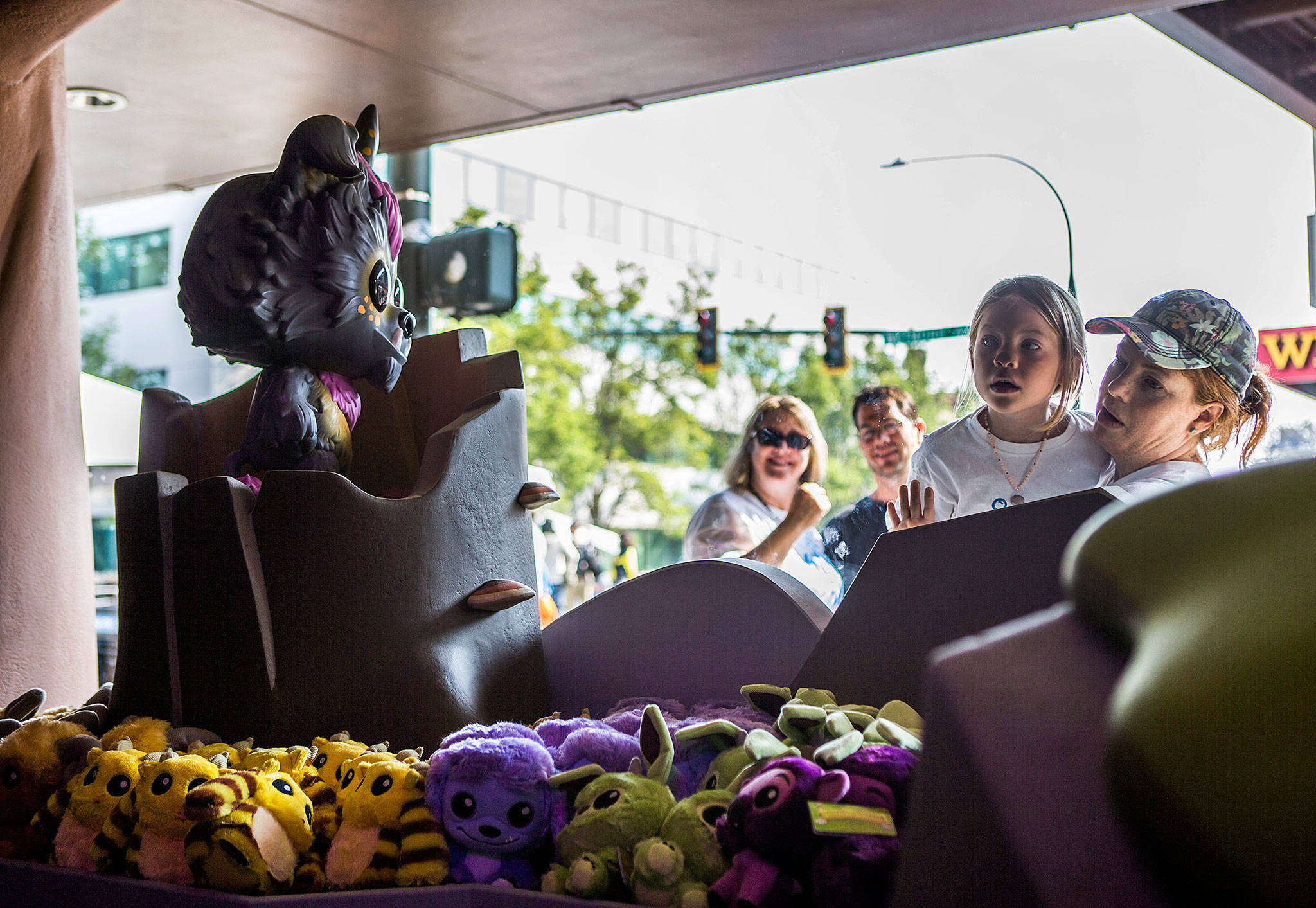 People peek into the window of the new Wetmore section of the Funko store at Funko’s Wetmore Block Party on Saturday. (Olivia Vanni / The Herald)