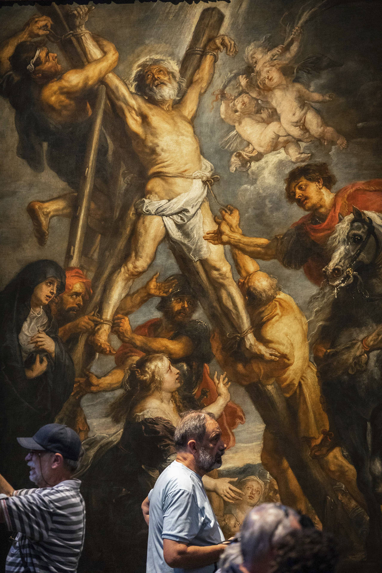 Visitors look at the painting “The Martyrdom of St. Andrew” by Flemish master Peter Paul Rubens on July 26 in the Rubenshouse in Antwerp, Belgium. (AP Photo/Olivier Matthys)