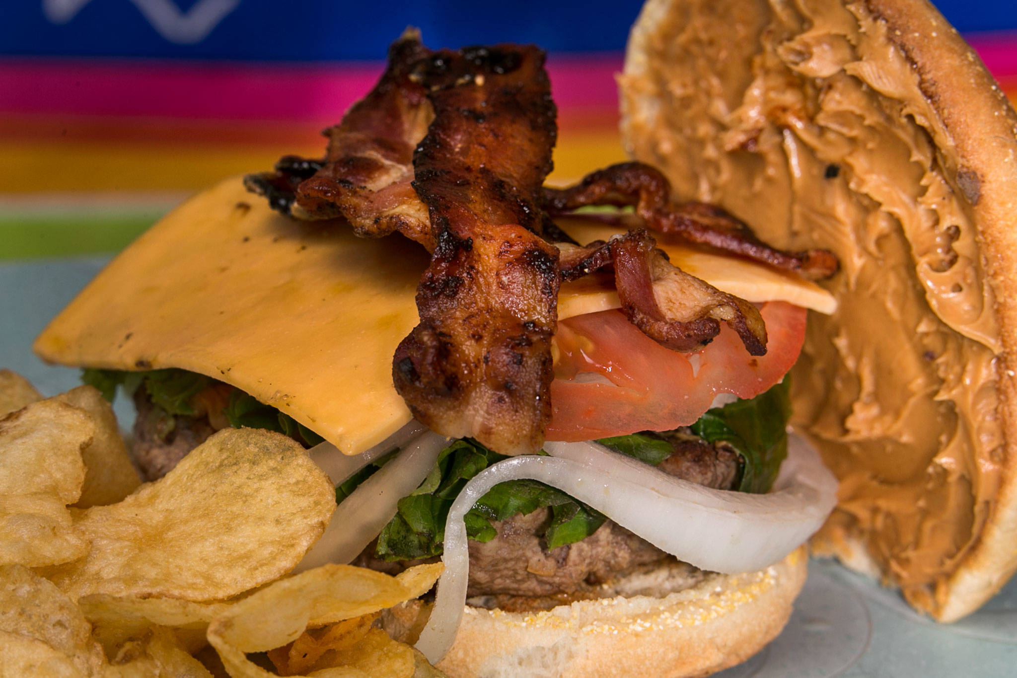 Peanut butter burger with lettuce, onions, tomatoes and peanut butter as a spread. (Kevin Clark / The Herald)