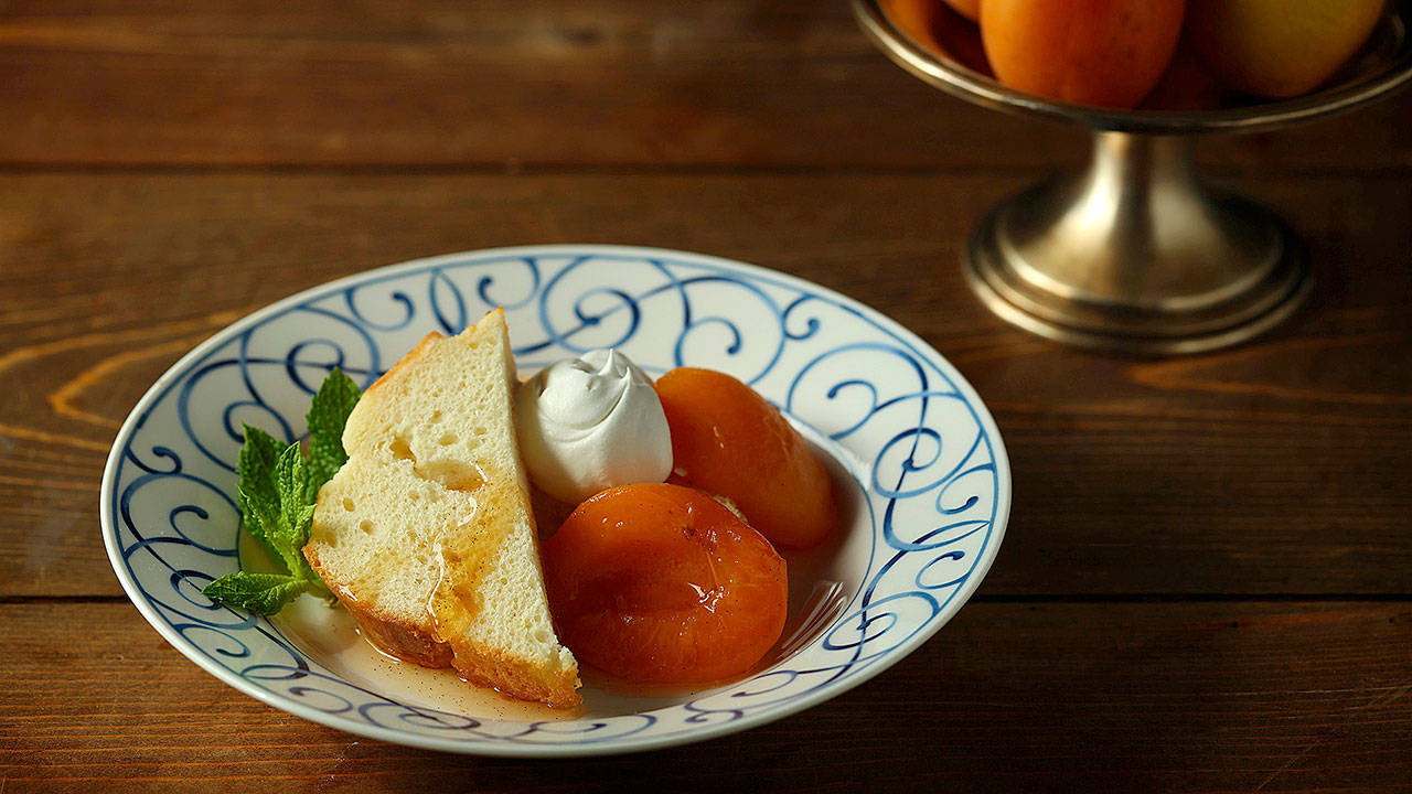 Apricots are poached in a water bath simply flavored with sugar, lemon juice and vanilla bean, creating a dessert whose payoff is much greater than the sum of its parts. (E. Jason Wambsgans/Chicago Tribune)