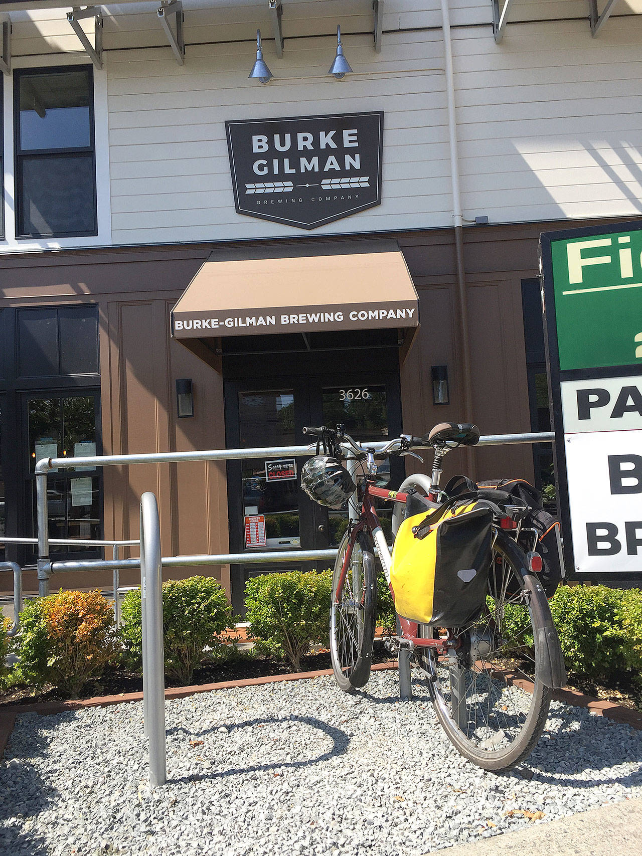 Burke Gilman Brewing co-owner Eric Lundquist parks his bike in front of the brewery in Seattle on July 27. Located near the Burke-Gilman Trail, the brewery is a favorite of bike riders since it opened last month. (Aaron Swaney / The Herald)