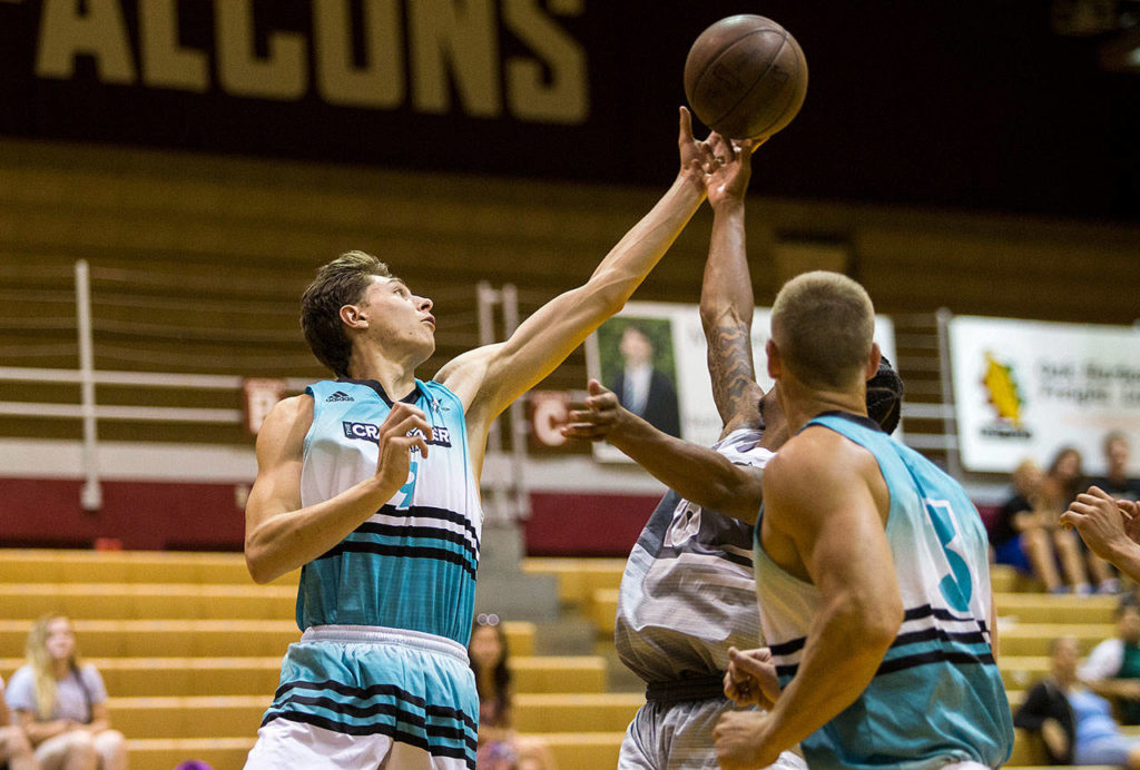 Colby Kyle reaches for a rebound during a CrawsOver Pro-Am League game at Seattle Pacific University on July 29. (Olivia Vanni / The Herald)
