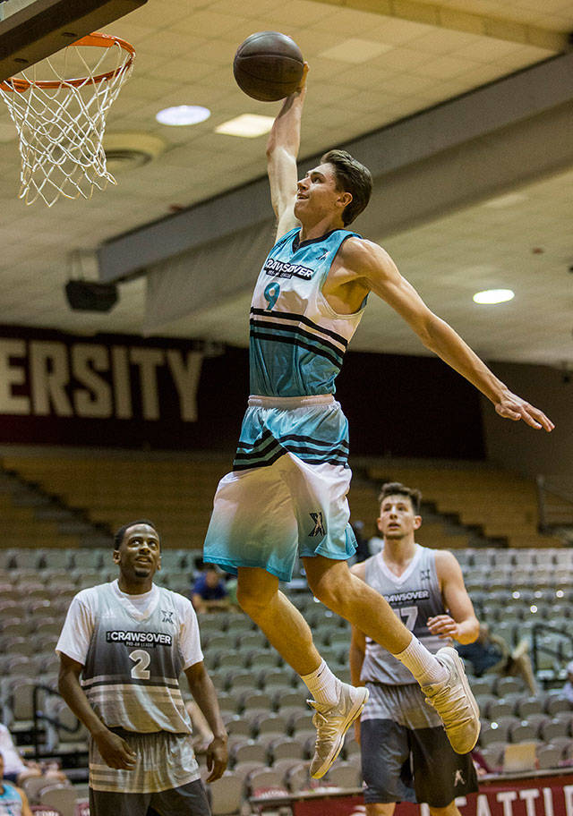 Colby Kyle jumps for a slam dunk during the final seconds of a CrawsOver Pro-Am League game at Seattle Pacific University on July 29. (Olivia Vanni / The Herald)